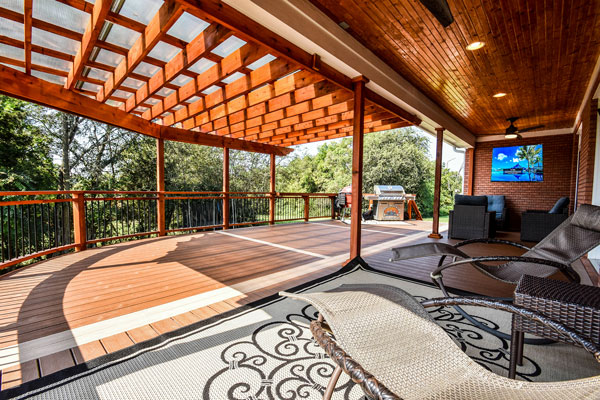 Image of a large covered deck that surrounds the corner of a home.